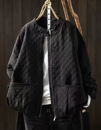 Ivory diamond-quilted women's jacket with snap collar and front zipper on a hanger