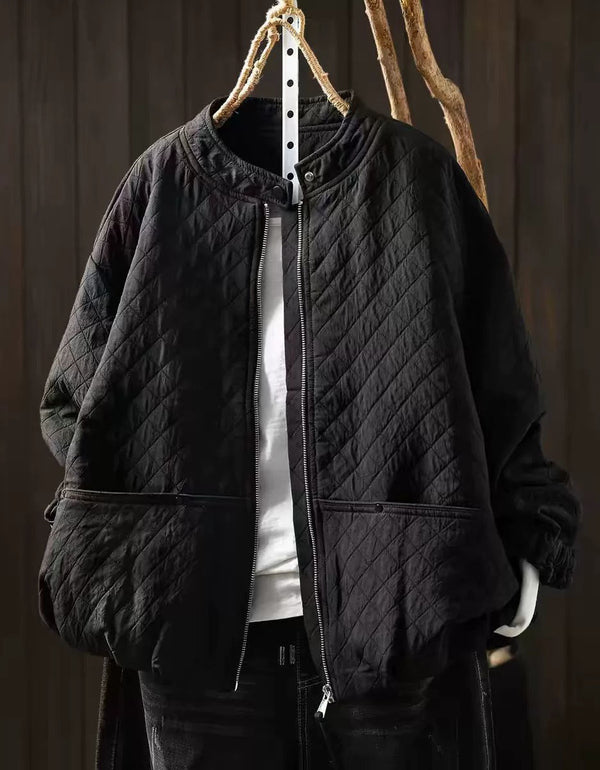 Ivory diamond-quilted women's jacket with snap collar and front zipper on a hanger