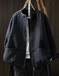 Ivory diamond-quilted jacket with oversized sleeves and roomy front pockets with snap details