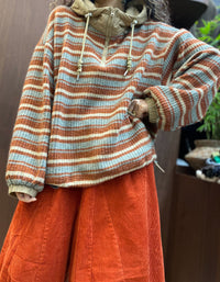 Women's relaxed striped knit hoodie styled with dark wide-leg casual trousers