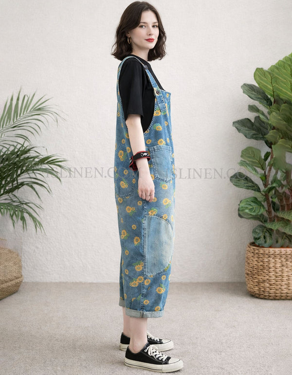 Side view of large front pocket detail on women’s loose-fit denim overalls 