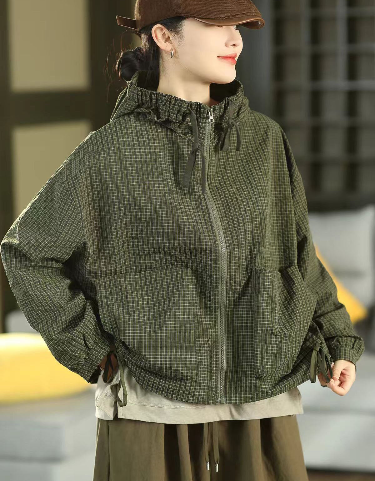 Back view of a women's relaxed-fit checkered hooded jacket in olive green