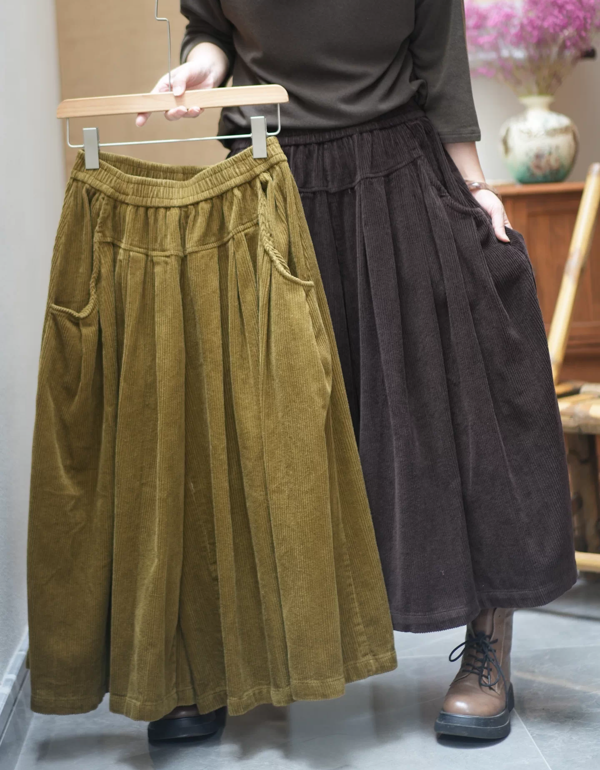 Women's wide leg corduroy culotte pants styled with a casual top and ankle boots