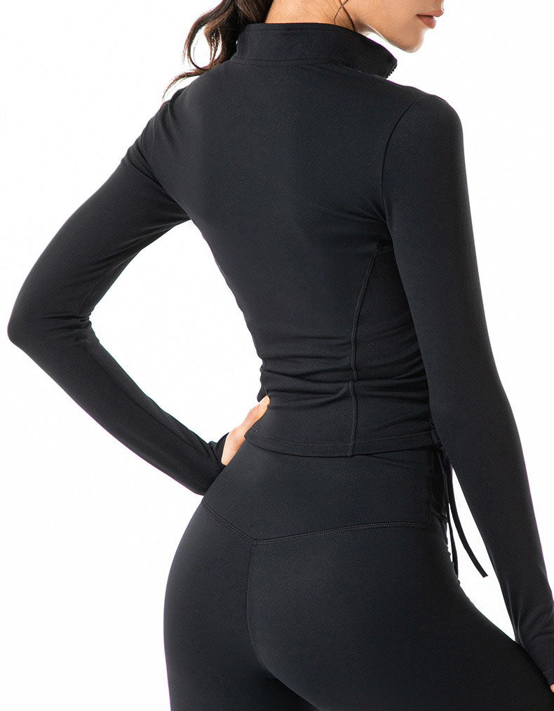 Black long-sleeve athletic top worn by a person on a white background