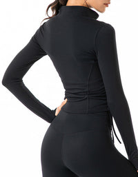 Black long-sleeve athletic top worn by a person on a white background