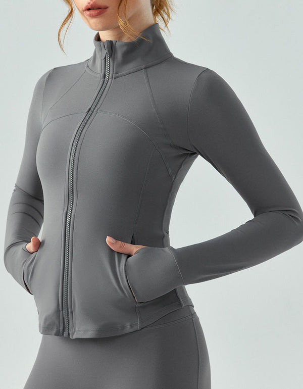 Gray athletic jacket worn by a person on a light gray background