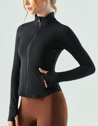 Person wearing a black long-sleeve athletic top with a zipper on a light gray background