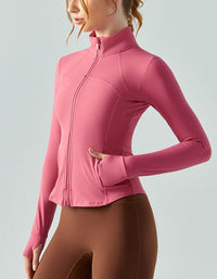 Person wearing a pink long-sleeve athletic jacket on a light gray background