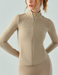 Beige athletic jacket worn by a person on a light gray background
