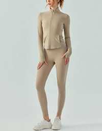 Person wearing a beige athletic outfit on a light gray background full view