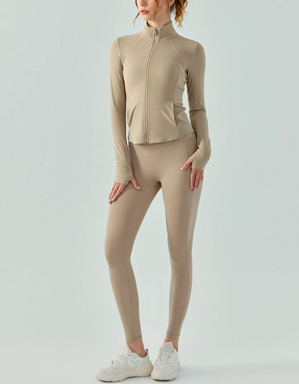 Person wearing a beige athletic outfit on a light gray background full view