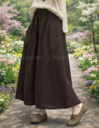 Ankle-length linen skirt with relaxed A-line silhouette on garden pathway.