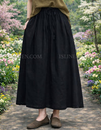 Long natural linen skirt with pockets styled for casual summer wear.