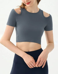 Person wearing a gray crop top with cut-out shoulders on a white background