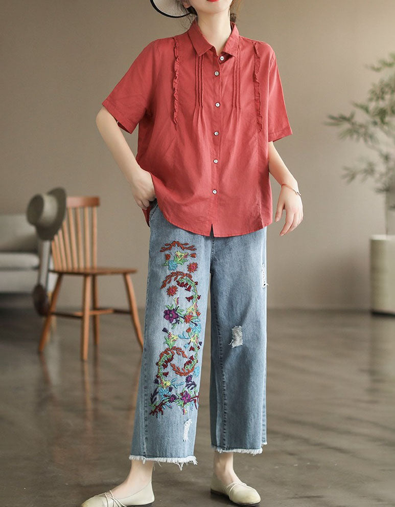 Front view of cropped wide-leg denim pants with floral embroidery