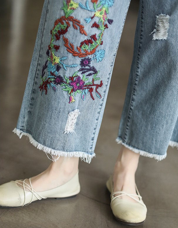 Close-up of embroidered detail on women’s cropped denim pants