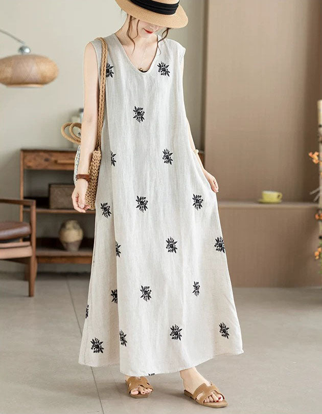 Side view of loose fit embroidered sleeveless linen blend dress
