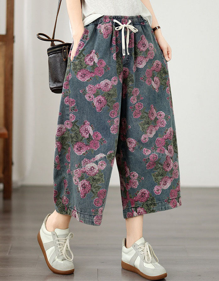 Side view of oversized floral denim pants with cropped hem