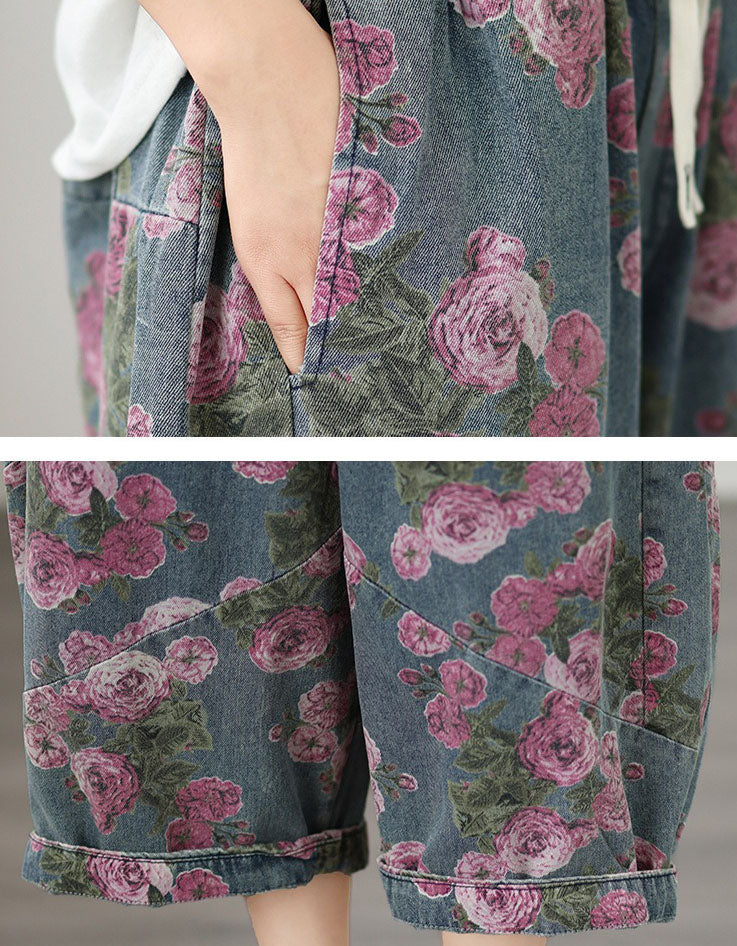 Close-up of pink rose floral print on washed denim fabric pants