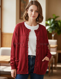 Woman wearing a red cardigan over a white shirt in an indoor setting