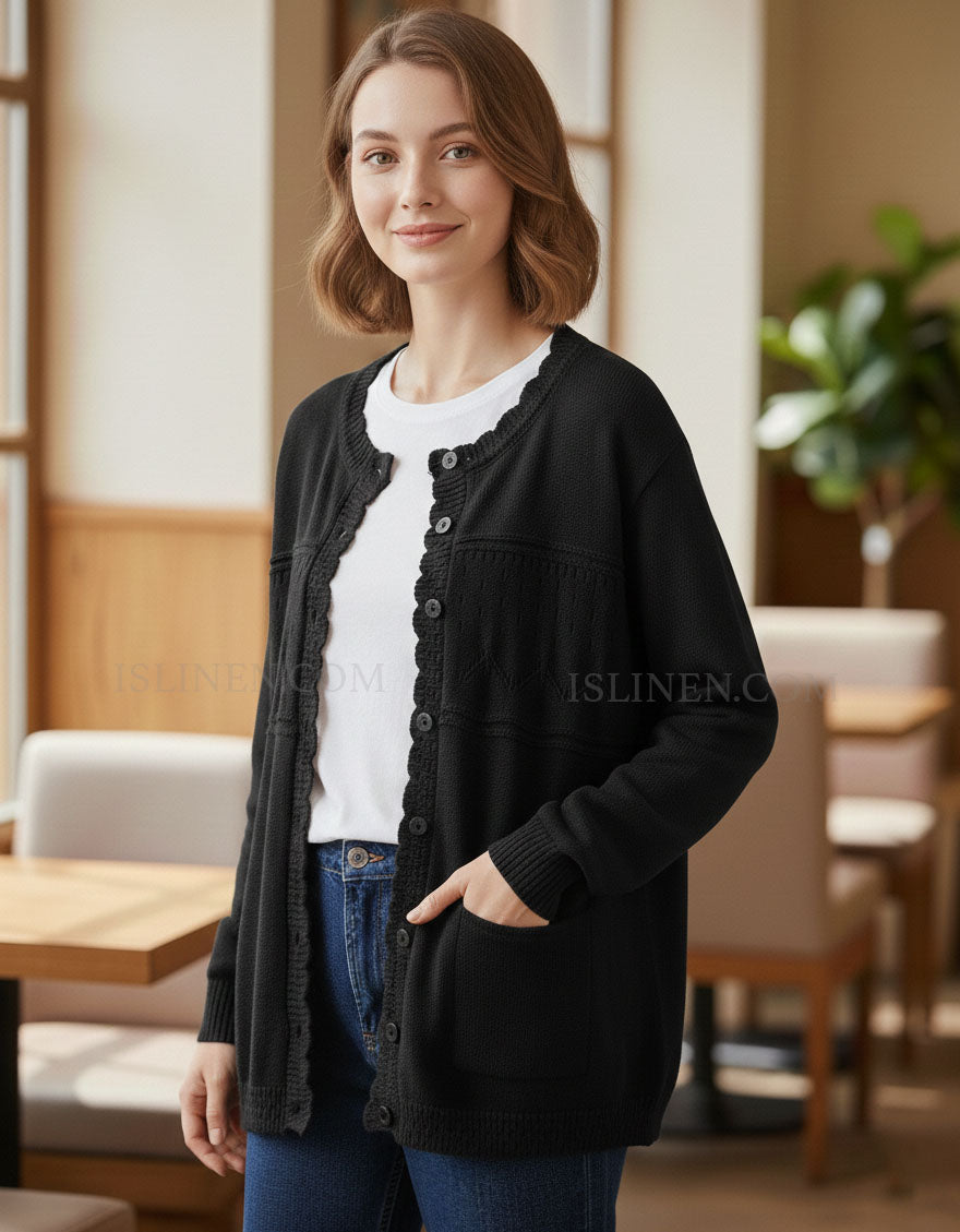 Woman wearing a black cardigan over a white shirt in a casual setting