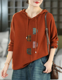Women's orange vintage patchwork hooded knit sweater with colorful appliqué details