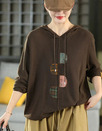 Women's relaxed fit hooded knit sweater in mustard coffee with patchwork front details