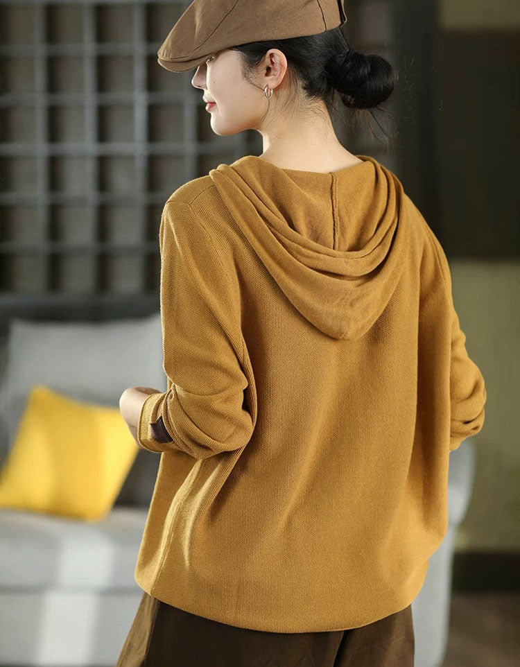 Back view of women's vintage mustard hooded knit sweater