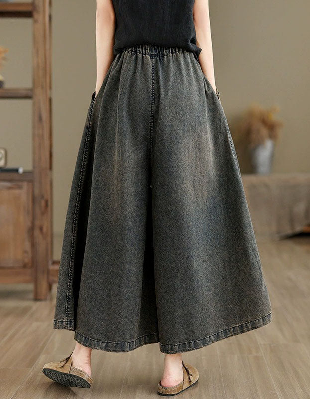 Back view of loose fit embroidered denim culottes with drawstring waist for women