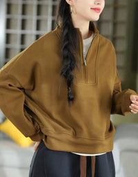 Women's oversized brown quarter-zip sweatshirt with a relaxed fit and long sleeves, front view