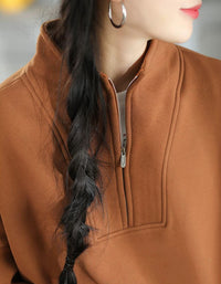 Relaxed-fit women's brown pullover sweatshirt with dropped shoulders and loose long sleeves