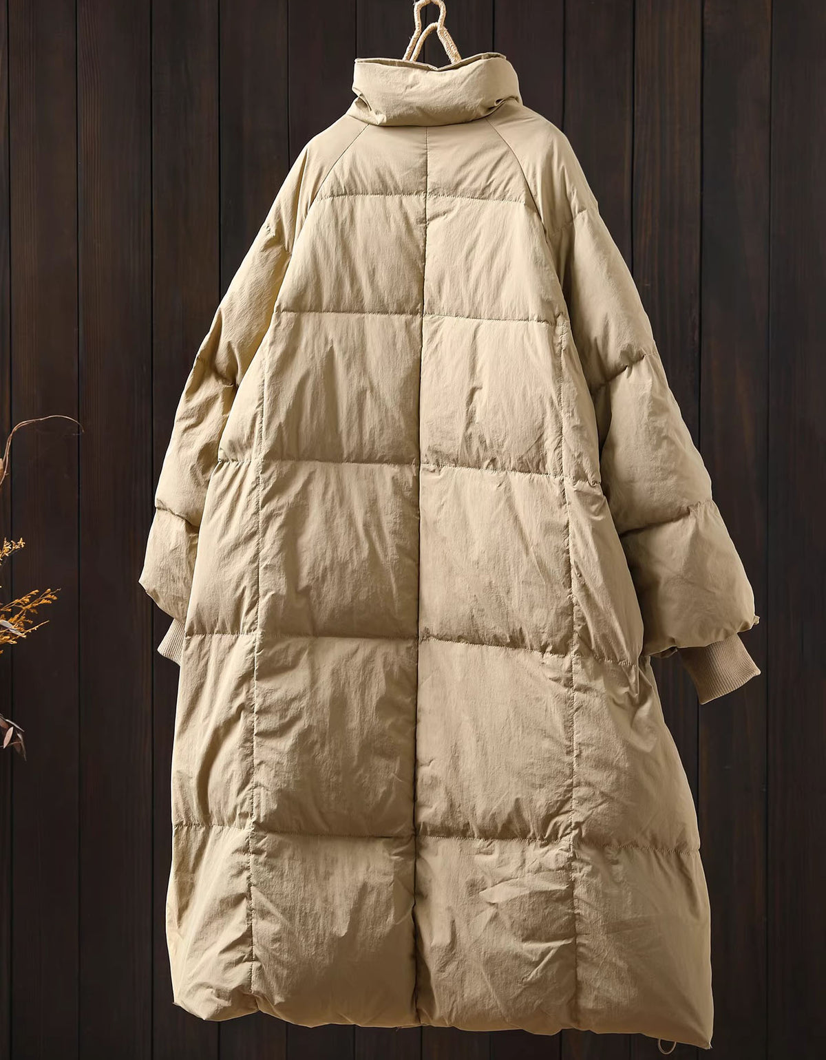 Back view of women’s long puffer coat, showcasing the warm and cozy design