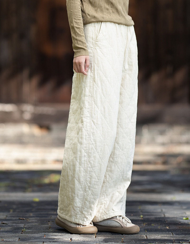 Linen side view of loose-fit quilted winter pants with pocket