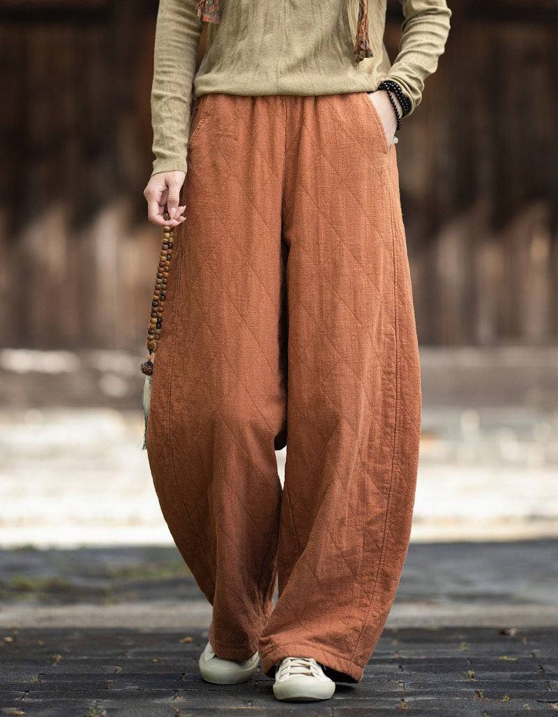Orange Side view of loose-fit quilted winter pants with pocket