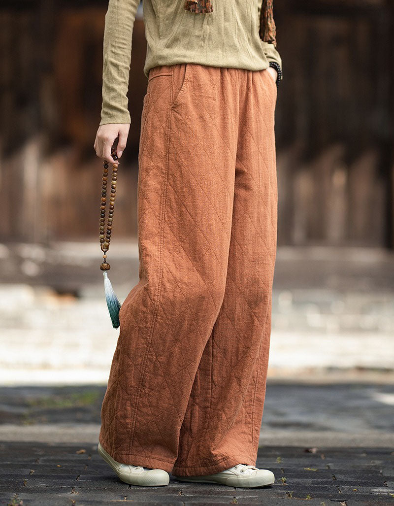 Orange side view of loose-fit quilted winter pants with pocket