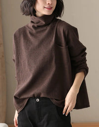 Long sleeve and relaxed fit details of a brown women’s sweater