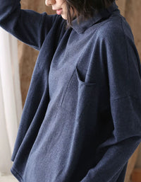 Side view of a women’s blue relaxed fit high neck sweater