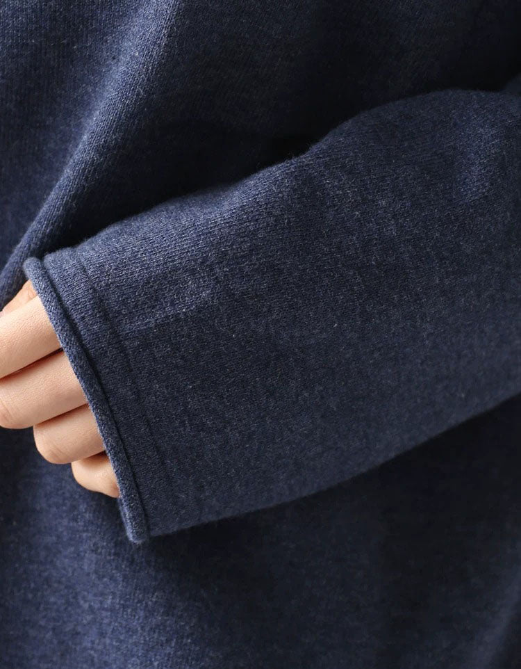 Close-up of the textured blue fabric on a women’s sweater