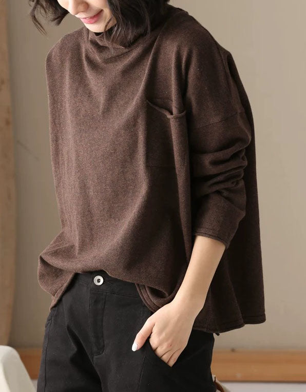 Women’s brown turtleneck top styled with black casual trousers