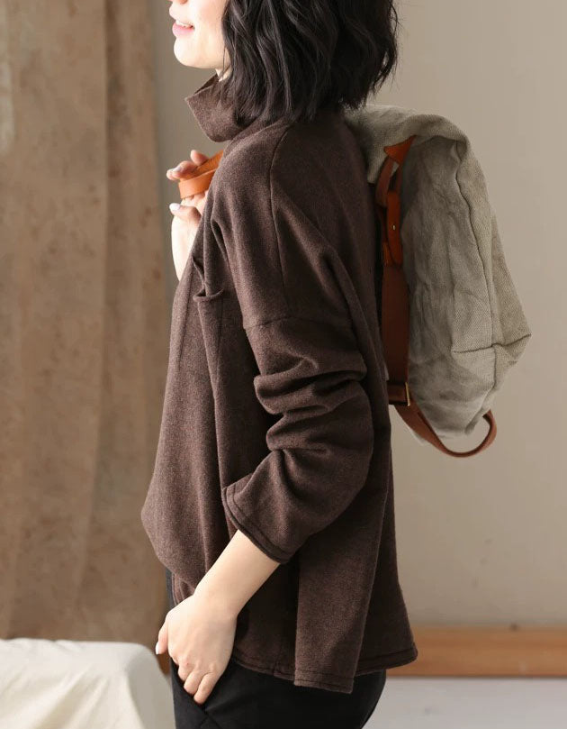 Side view of a women’s brown relaxed fit high neck sweater