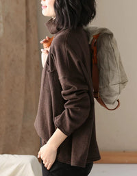 Side view of a women’s brown relaxed fit high neck sweater