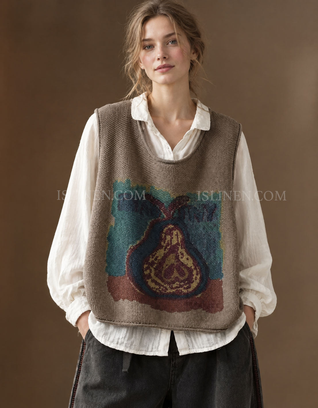 Women's taupe vintage pear graphic knit sweater vest layered over a white blouse