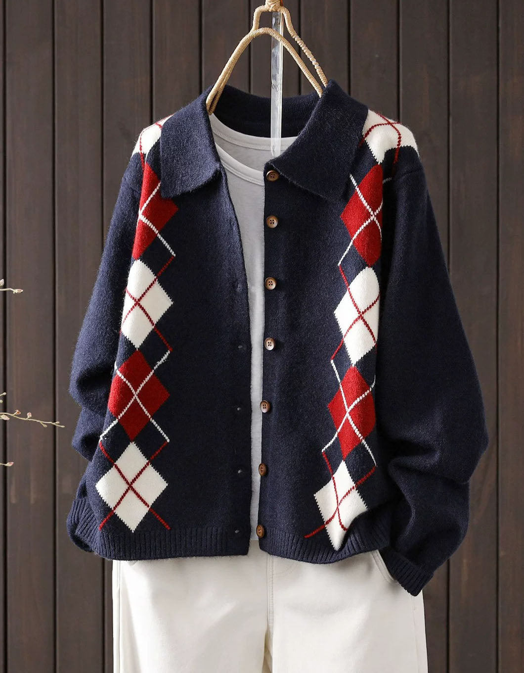 Women's navy argyle knit cardigan with collar and brown buttons, front view