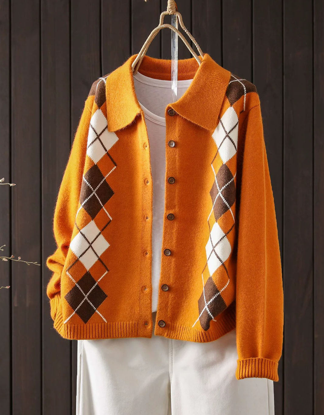 Orange knit cardigan featuring a wide collar and brown button-front closure