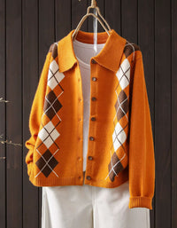 Orange knit cardigan featuring a wide collar and brown button-front closure