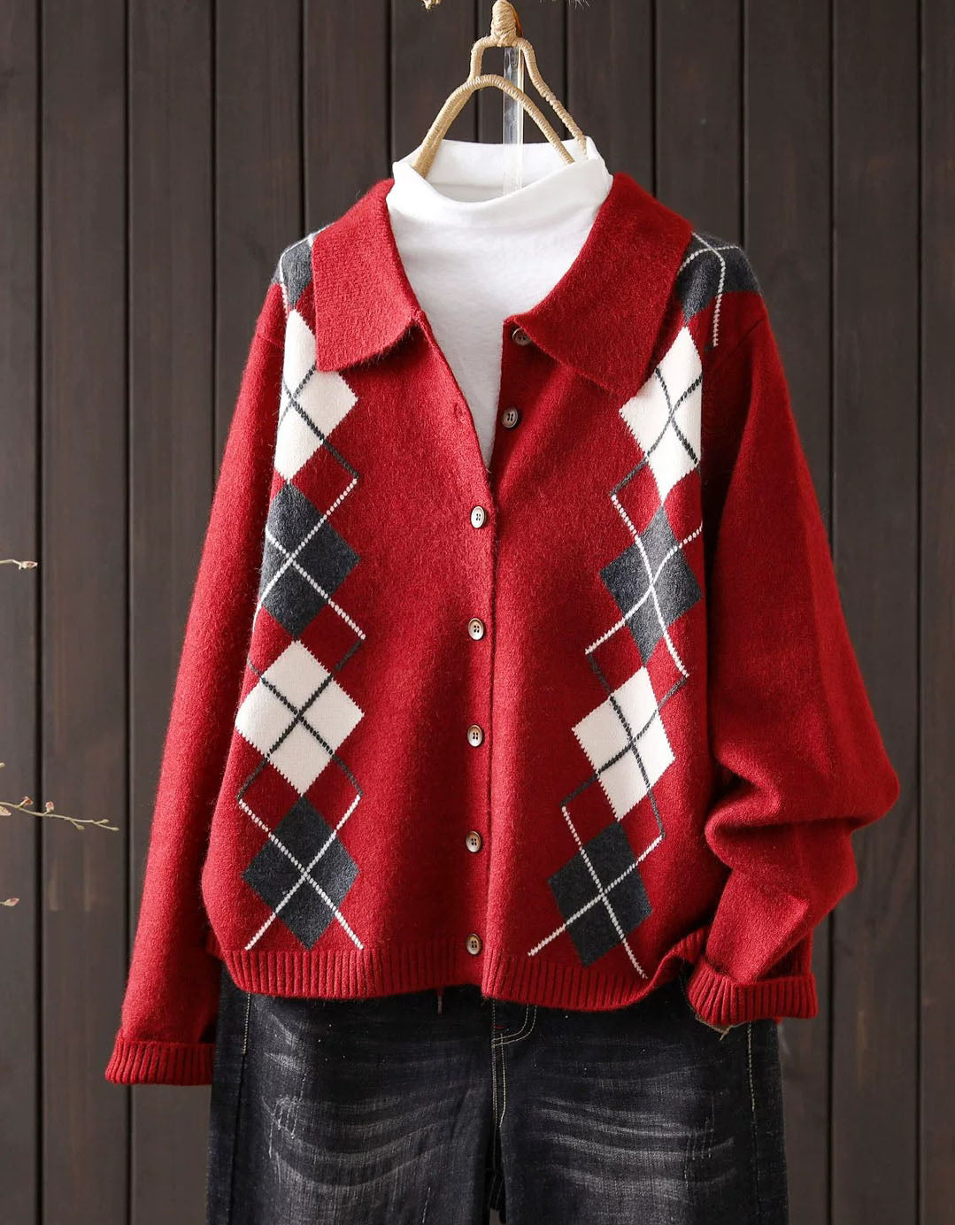 Women's red argyle knit cardigan with collar and brown buttons, front view