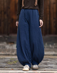 Gathered ankle cuffs on women's navy balloon trousers with a relaxed fit