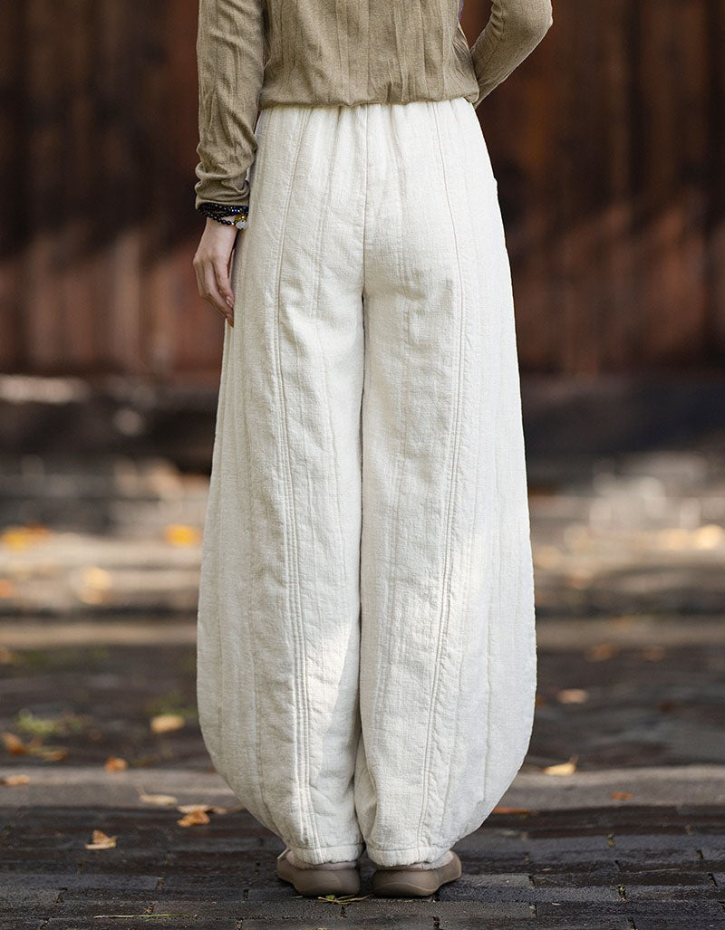Back view of women's relaxed balloon harem pants in textured linen fabric