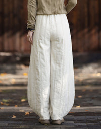 Back view of women's relaxed balloon harem pants in textured linen fabric