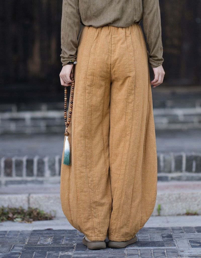 Gathered ankle cuffs on women's yellow balloon trousers with a relaxed fit